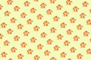 Creative pattren made of dried  leaves on pastel sunlit background with shadow. Autumn, fall, thanksgiving day concept. Flat lay, top view. Minimal style