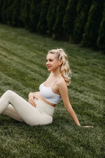 Pregnant Woman Wearing Sportswear Sitting Green Grass Holding Hand Belly — Stock Photo, Image