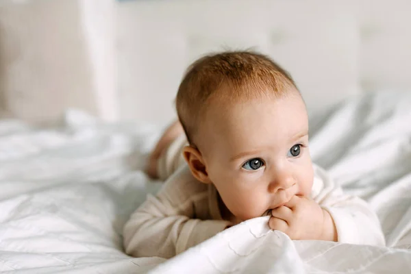 Κοντινό Πλάνο Ενός Μωρού Ξαπλωμένο Στο Κρεβάτι Την Κοιλιά Μασώντας — Φωτογραφία Αρχείου