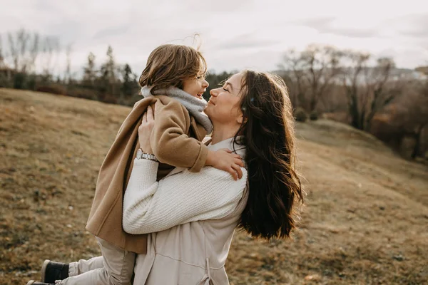 Mother Holding Her Son Arms Outdoors Autumn Day — Stockfoto
