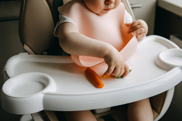 Baby Sitting High Chair Silicone Bib Eating Vegetables Stock Picture