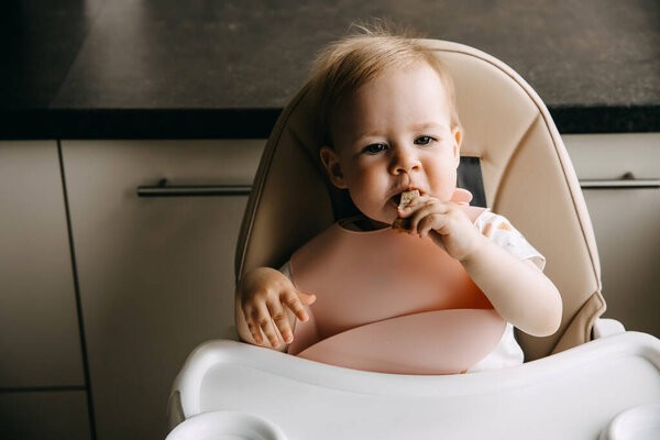 Baby Sitting High Chair Silicone Bib Eating Bread Stock Photo