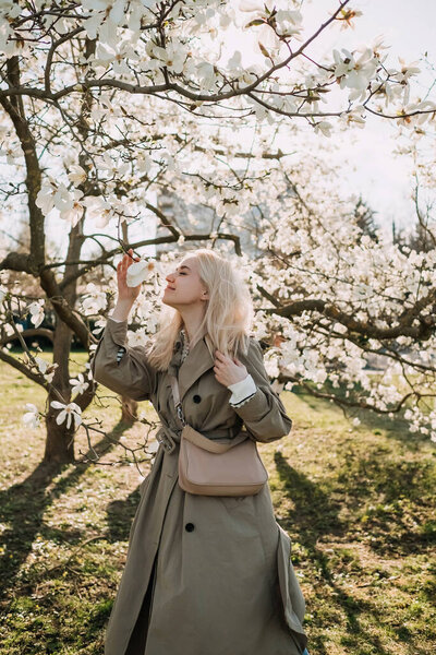 Young Blonde Woman Smelling Magnolia Flower Sunny Day Park Stock Image