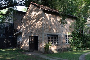 Shadow of the trees on the red brick house in the wood