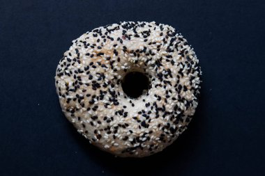traditional tasty bagel with sesame on white background