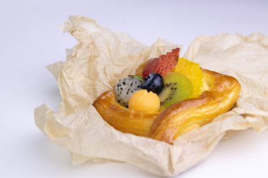 Mixed Fruit Danish Wrapped with Brown Paper on White Background