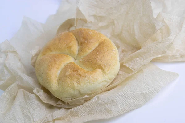 Kaiser Roll Tasty Bread Roll Wrapped Brown Paper White Background — 图库照片