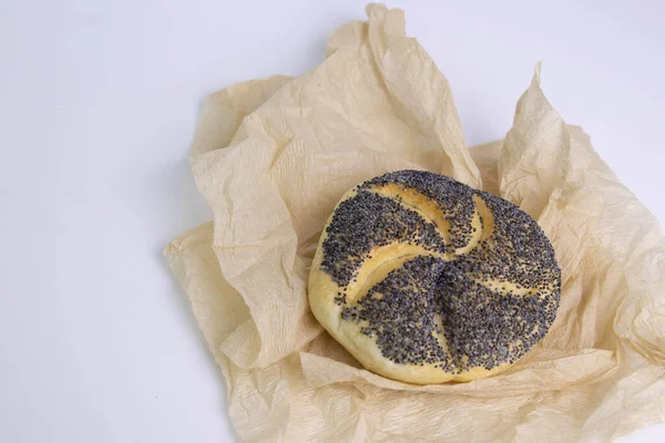 Poppy Seeds Kaiser Roll Wrapped Brown Paper White Background —  Fotos de Stock