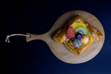 Mixed Fruit Danish Wrapped with Brown Paper on White Background