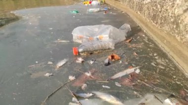Large Environmental Pollution. Plastic Bottles, Bags, Trash In River Or Lake
