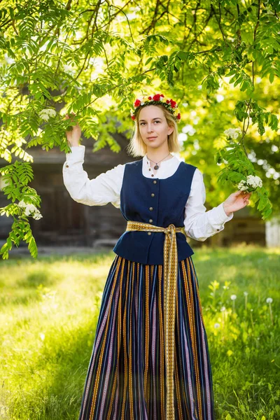 Lettische Frau in traditioneller Kleidung posiert in einem Dorf in der Natur. — Stockfoto