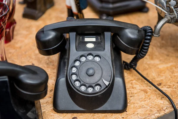 Retro old black telephone on the table.