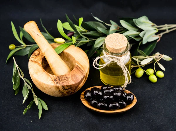 cold pressed olive oil with branch and fruits
