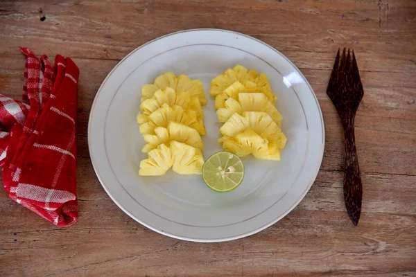 Pineapple fruit dessert, served on the white plate.
