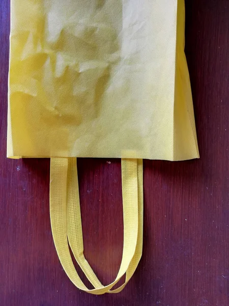 Yellow Bag Placed Brown Wooden Background — стоковое фото