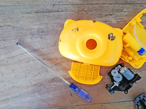 Kahverengi ahşap arka planda bir çocuk oyuncağını tamir etmek (BUBLE CAMERA)