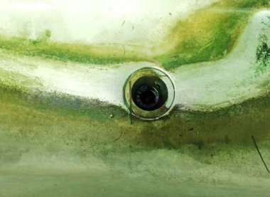 Dirty mossy wash tank in close up