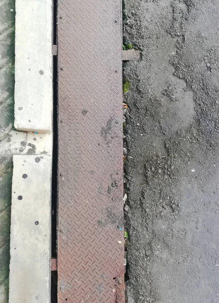 Drainage system at the road,with metal material cover