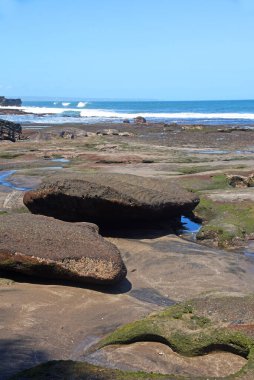 Rock formation at the south area of Bali island,with black sand beach