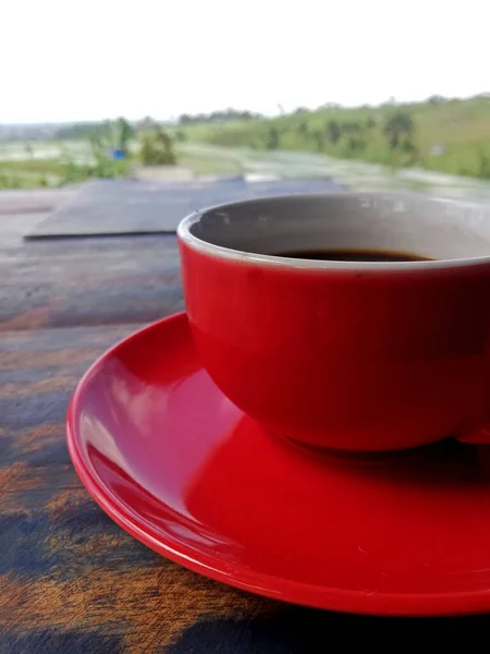 Black Coffee Red Color Cup Placed Wooden Table Rice Field — Zdjęcie stockowe