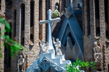 Barcelona, Spain - May 28 2022: In the frame is the famous Sagrada Familia basilica during construction. Close-up of the details of the architecture of the cathedral.