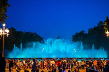 Barcelona, Spain - May 28 2022: Night Photograph Of The Performance Of The Singing Magic Fountain Of Montjuic In Barcelona, Catalonia, Spain. Crowd Of People Are Watching The Performance.