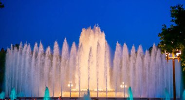 Barcelona, Spain - May 28 2022: Night Photograph Of The Performance Of The Singing Magic Fountain Of Montjuic In Barcelona, Catalonia, Spain. Crowd Of People Are Watching The Performance.