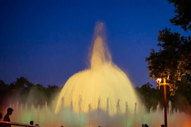 Barcelona, Spain - May 28 2022: Night Photograph Of The Performance Of The Singing Magic Fountain Of Montjuic In Barcelona, Catalonia, Spain. Crowd Of People Are Watching The Performance.