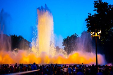 Barcelona, Spain - May 28 2022: Night Photograph Of The Performance Of The Singing Magic Fountain Of Montjuic In Barcelona, Catalonia, Spain. Crowd Of People Are Watching The Performance.