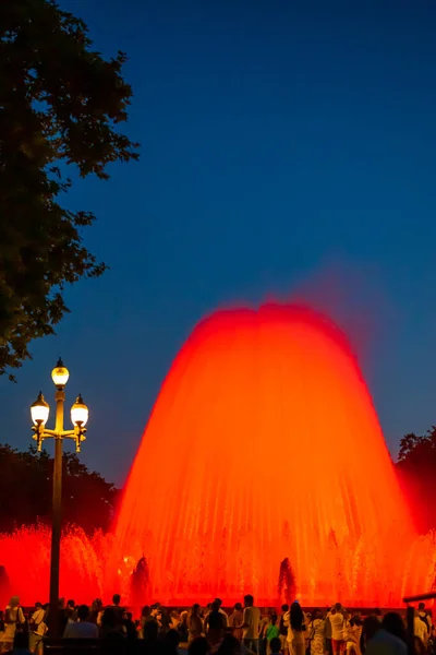 Barcelona, Spain - May 28 2022: Night Photograph Of The Performance Of The Singing Magic Fountain Of Montjuic In Barcelona, Catalonia, Spain. Crowd Of People Are Watching The Performance.