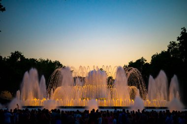 Barcelona, Spain - May 28 2022: Night Photograph Of The Performance Of The Singing Magic Fountain Of Montjuic In Barcelona, Catalonia, Spain. Crowd Of People Are Watching The Performance.