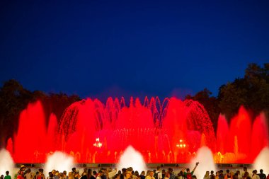 Barcelona, Spain - May 28 2022: Night Photograph Of The Performance Of The Singing Magic Fountain Of Montjuic In Barcelona, Catalonia, Spain. Crowd Of People Are Watching The Performance.