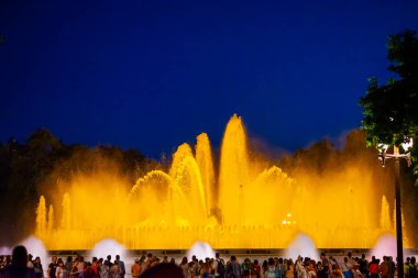 Barcelona, Spain - May 28 2022: Night Photograph Of The Performance Of The Singing Magic Fountain Of Montjuic In Barcelona, Catalonia, Spain. Crowd Of People Are Watching The Performance.