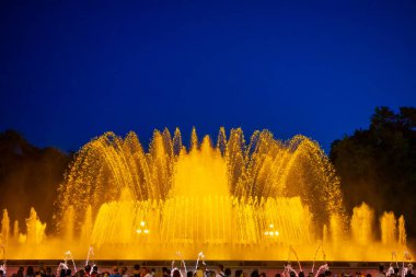 Barcelona, Spain - May 28 2022: Night Photograph Of The Performance Of The Singing Magic Fountain Of Montjuic In Barcelona, Catalonia, Spain. Crowd Of People Are Watching The Performance.