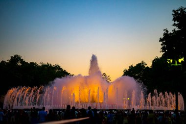Barcelona, Spain - May 28 2022: Night Photograph Of The Performance Of The Singing Magic Fountain Of Montjuic In Barcelona, Catalonia, Spain. Crowd Of People Are Watching The Performance.