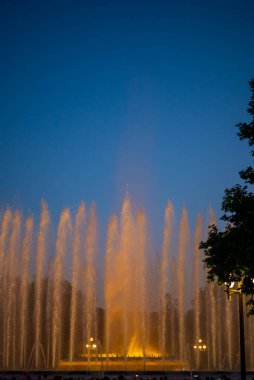 Barcelona, Spain - May 28 2022: Night Photograph Of The Performance Of The Singing Magic Fountain Of Montjuic In Barcelona, Catalonia, Spain. Crowd Of People Are Watching The Performance.