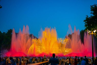 Barcelona, Spain - May 28 2022: Night Photograph Of The Performance Of The Singing Magic Fountain Of Montjuic In Barcelona, Catalonia, Spain. Crowd Of People Are Watching The Performance.