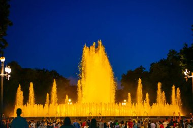 Barcelona, Spain - May 28 2022: Night Photograph Of The Performance Of The Singing Magic Fountain Of Montjuic In Barcelona, Catalonia, Spain. Crowd Of People Are Watching The Performance.
