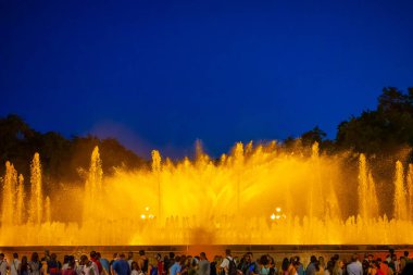 Barcelona, Spain - May 28 2022: Night Photograph Of The Performance Of The Singing Magic Fountain Of Montjuic In Barcelona, Catalonia, Spain. Crowd Of People Are Watching The Performance.
