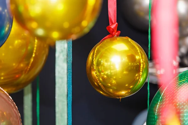 Christmas balls are hung on ribbons. Celebrating new year, christmas — Stockfoto