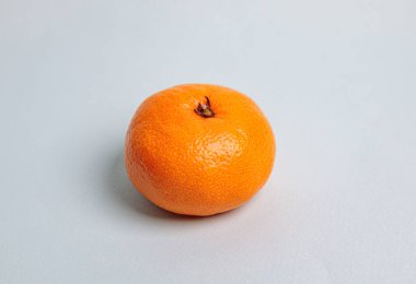 Mavi arka planda bir mandalina. Taze sağlıklı yiyecekler..
