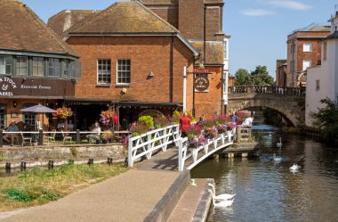 Newbury, Berkshire, İngiltere, İngiltere. 2021 yılı. Manzara, Newbury, İngiltere 'deki Kennet ve Avon kanallarının yanındaki eski kasaba köprüsüne ve çiçeklerle süslenmiş bir bara bakıyor..