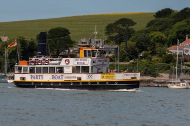 Falmouth, Cornwall, England, UK. 2022. Tourist trip boat off the Cornish coast outbound to tour the Helford River with passengers onboard. Cornwall, UK  