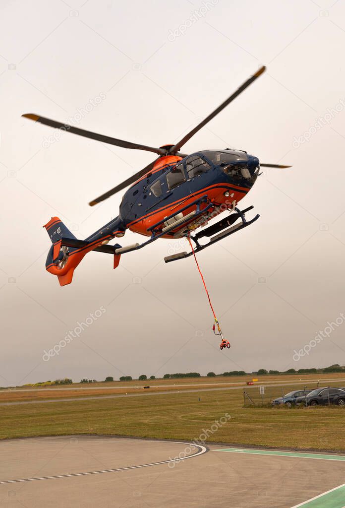 Cornwall, England, UK. 2022. Airlift helicopter with carrying strap and