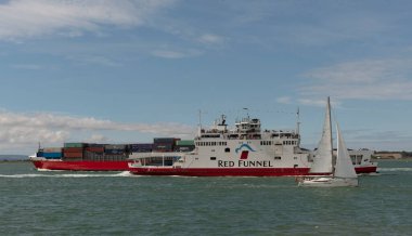 Southampton Water, southern England, UK. A selection of vessels alongside, an Isle of Wight  ferry, sailing boat, container carrier approaching the Solent. UK
