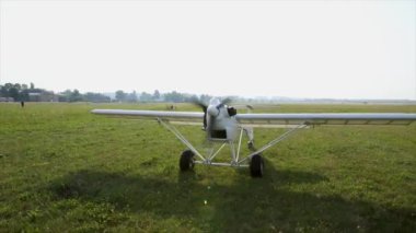 Unmanned aerial vehicle. UAV cargo delivery. The plane leaves the field for takeoff. The compact device on gasoline.