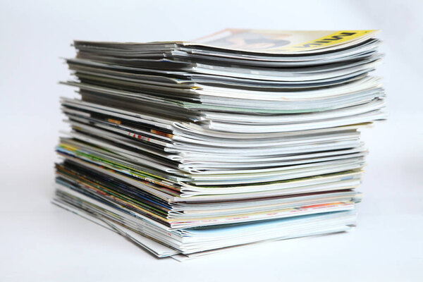 A large stack of printing magazines on a white background. Lots of different publications