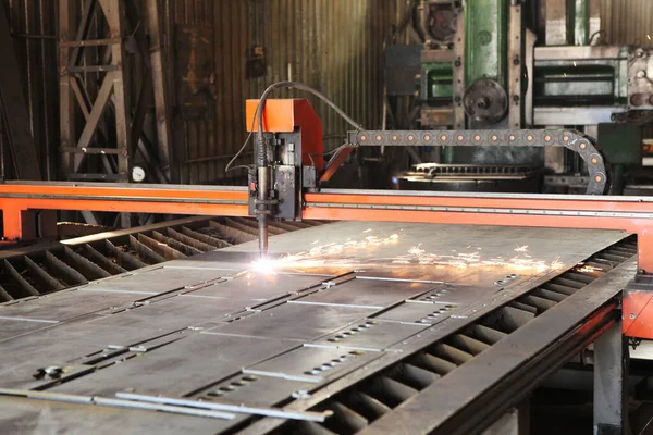 Laser cutting of metal. Automated machine for precise metal cutting. Plasma cuts steel. The machine is a robot