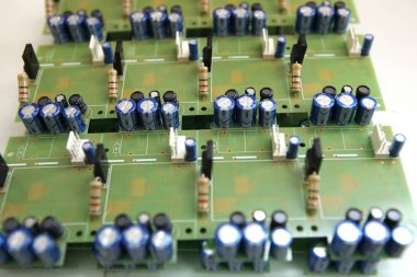 A man collects a printed circuit board. The worker solders the radio components and assembles the finished device. Manual assembly and control