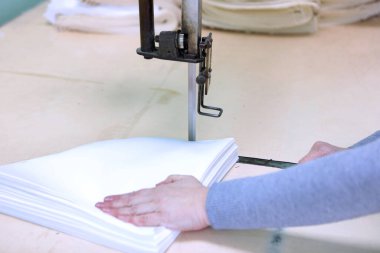 Shop for tailoring. A woman creates clothes on a sewing machine. Fashion industry for people. Stylish fashionista woman creating new cloth design collection. Tailor and sewing. People lifestyle and occupation concept.